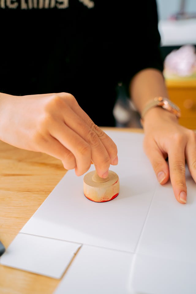woman holding a stamp of approval for higher education accreditation