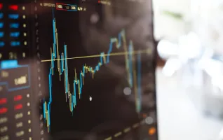 Close-up of a monitor screen showing finance stock changes