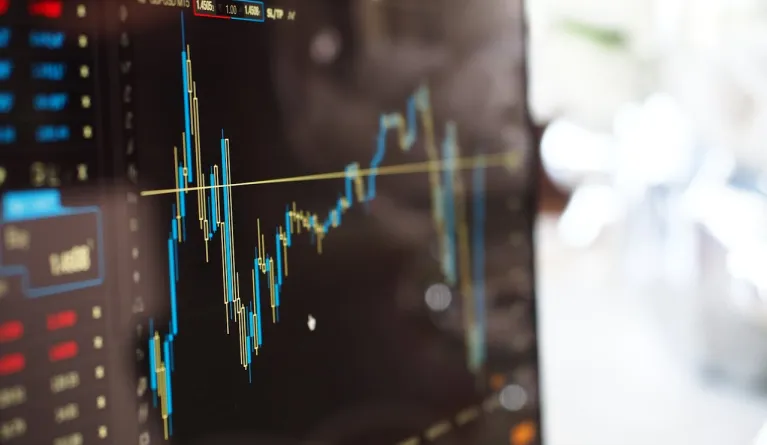 Close-up of a monitor screen showing finance stock changes