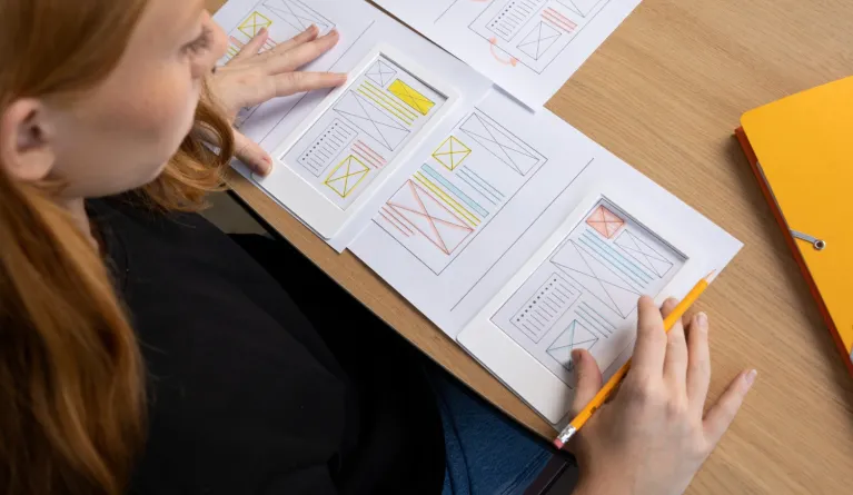 female web designer in the office looking at wireframes